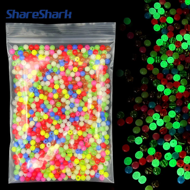 A clear plastic bag filled with mixed glow-in-the-dark fishing beads in various bright colors.