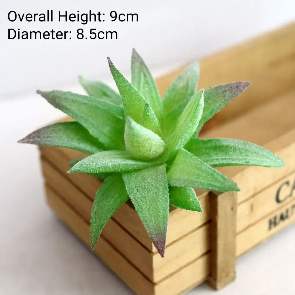 A green flocked artificial succulent plant with a 9cm height and 8.5cm diameter resting in a wooden box.