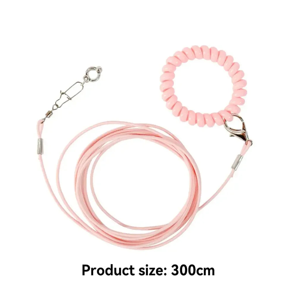 Pink parrot flight training leash with a circular foot ring coiled on a white background