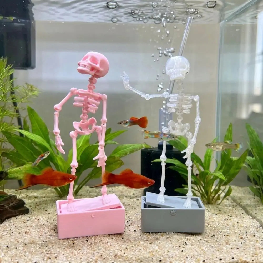 A pink skeleton figure and a white skeleton figure are displayed in an aquarium with bubbles.