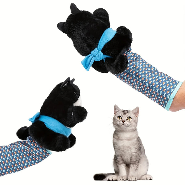 A black stuffed cat toy with blue fabric limbs is shown next to a gray tabby kitten.