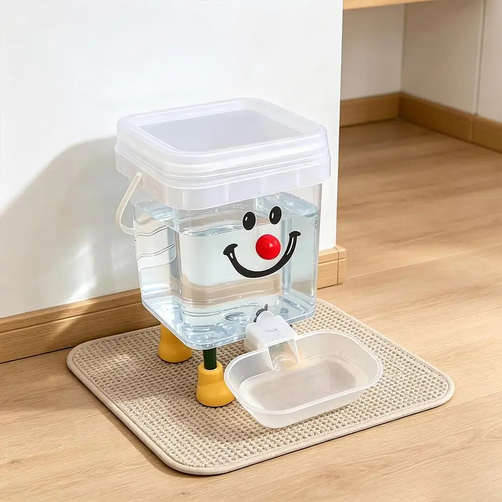 A clear plastic pet water fountain with a smiling face is placed on a beige mat.