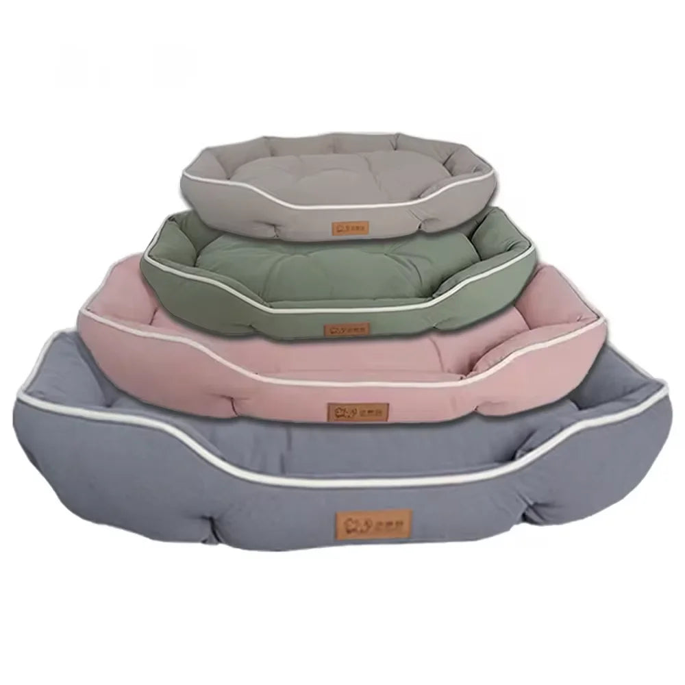 A stack of three luxurious corduroy pet sofa beds for dogs and cats in shades of gray, green, and pink.