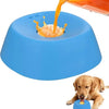 A dog is eating food from an orange liquid being poured into a blue ergonomic slow feeder bowl.