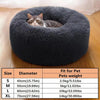 A gray tabby cat is resting inside a round, plush pet bed for dogs and cats.