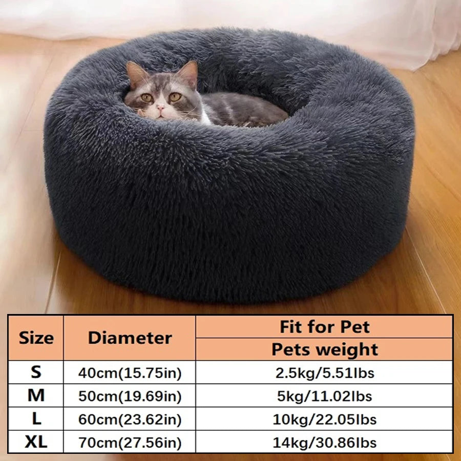 A gray tabby cat is resting inside a round, plush pet bed for dogs and cats.