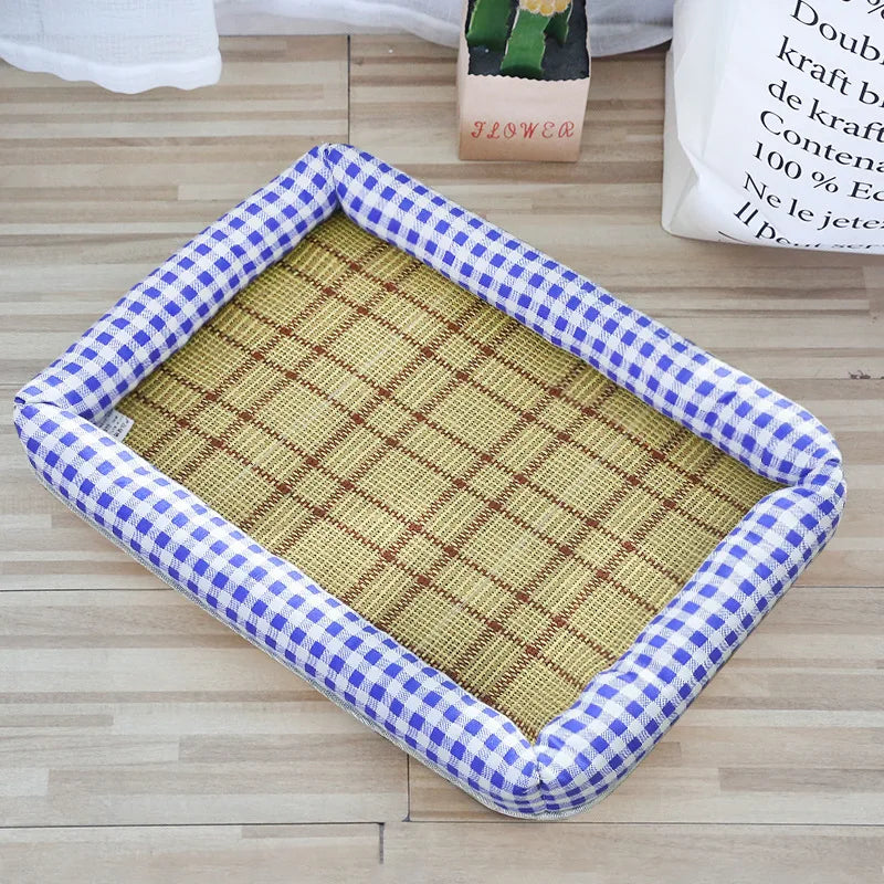 A rectangular pet bed with a blue and white checkered border and a woven tan mat is shown on a wooden floor.