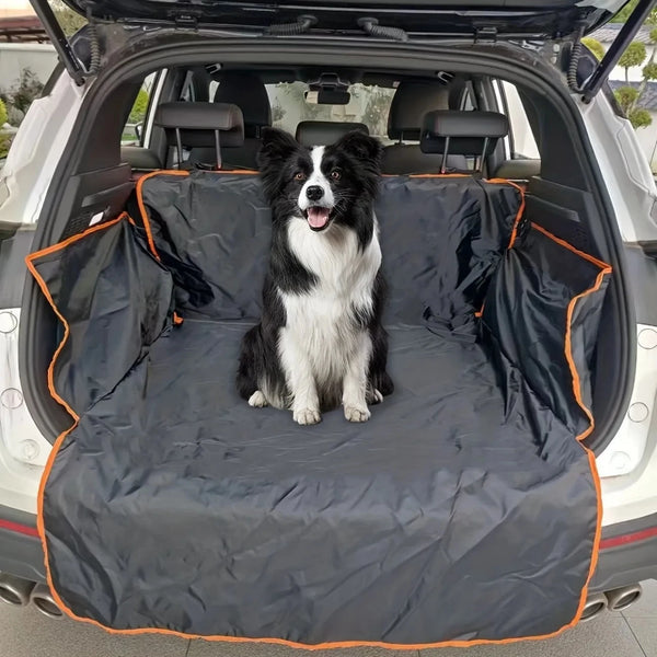 A black and white dog is sitting on a black waterproof SUV cargo liner inside the open trunk of a vehicle.