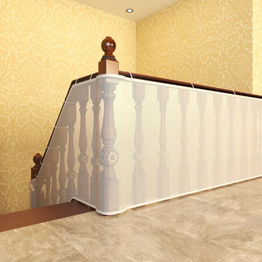 A white mesh safety barrier is installed along a wooden railing on an indoor staircase.
