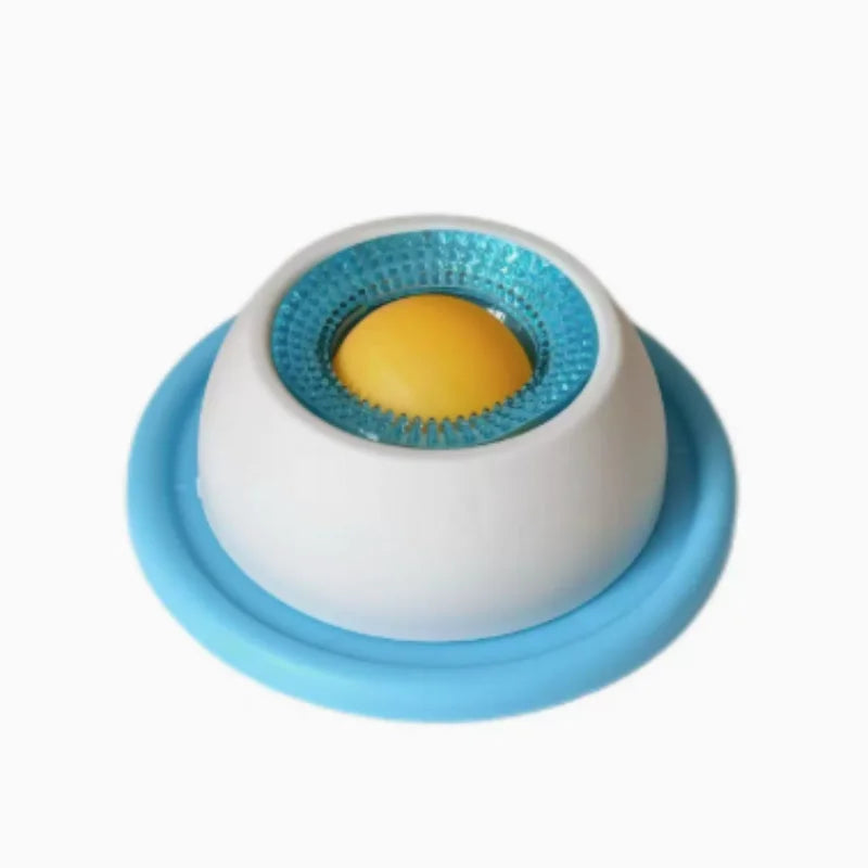 A white slow feeder mat with a blue silicone insert and a yellow ball for dog or cat feeding.