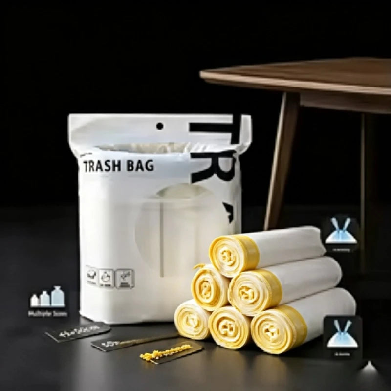 A white trash bag is shown next to rolled-up yellow drawstring bags and some black accessories.