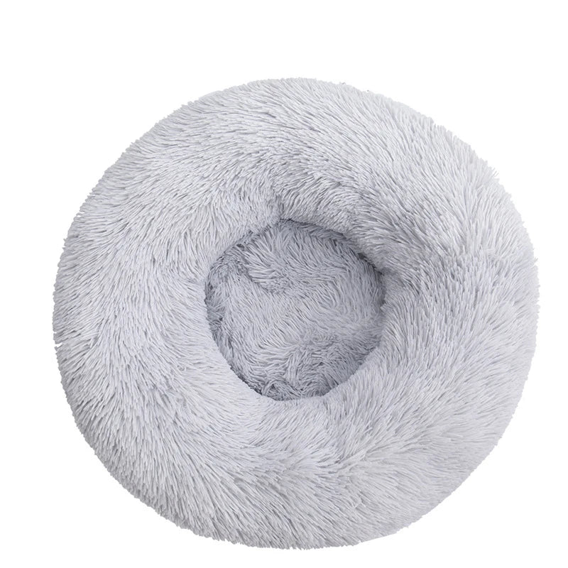 A round, light gray plush pet bed for dogs and cats.