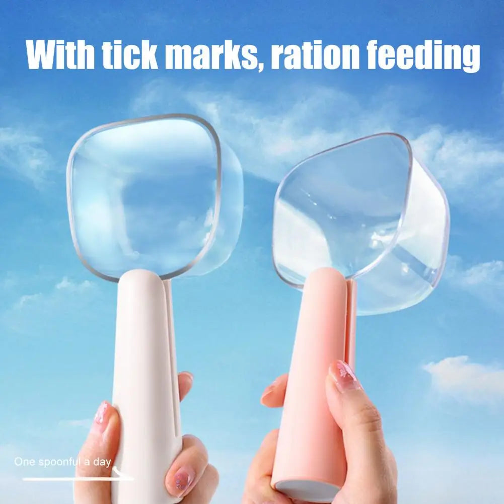 A person holds a white and pink 2-in-1 pet food measuring scoop used for feeding with tick marks against a blue sky backgroun
