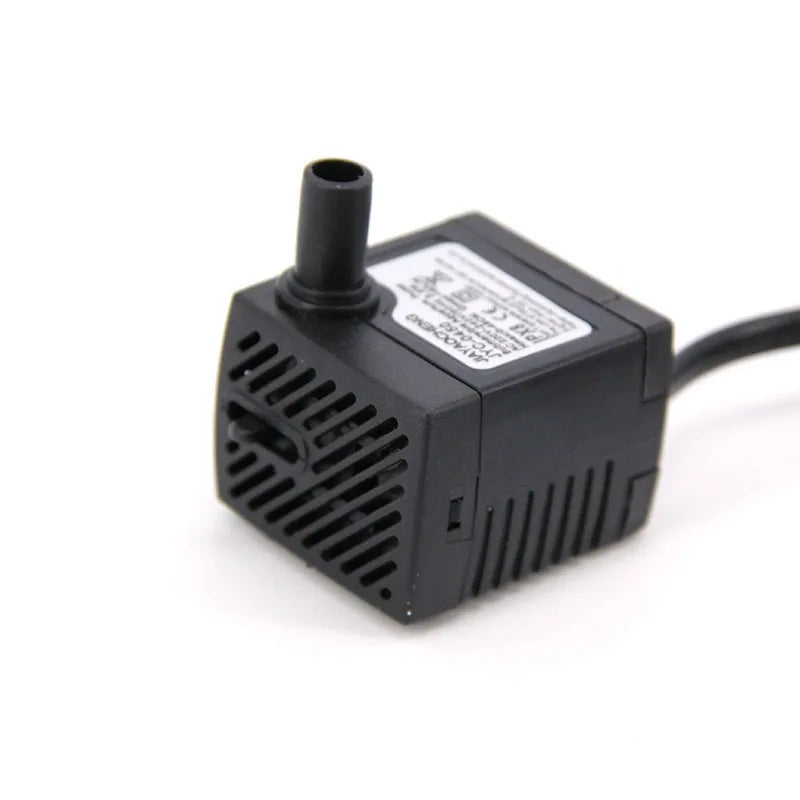 A black submersible aquarium water pump with a nozzle and electrical cord.