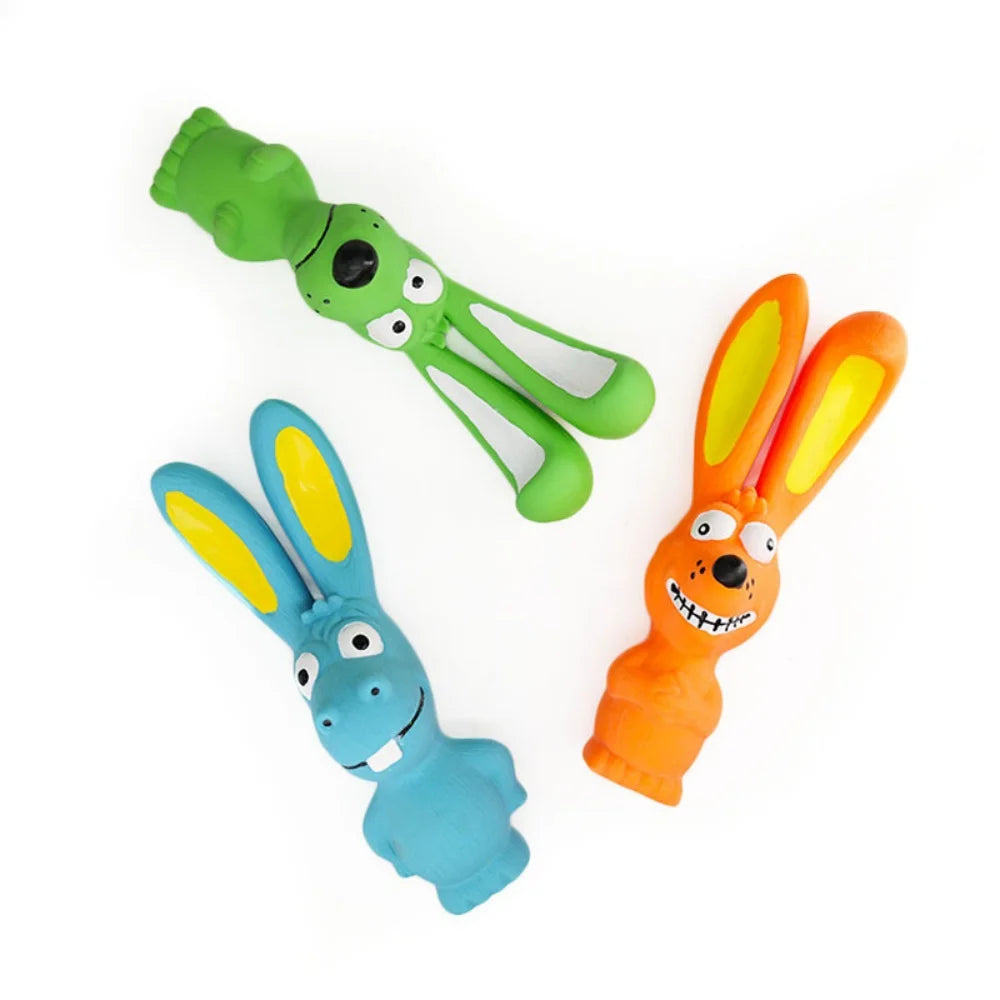 A set of three natural rubber squeaky rabbit chew toys for dogs in green, orange, and blue.