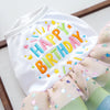 White dog birthday suit with colorful lettering and floral trim