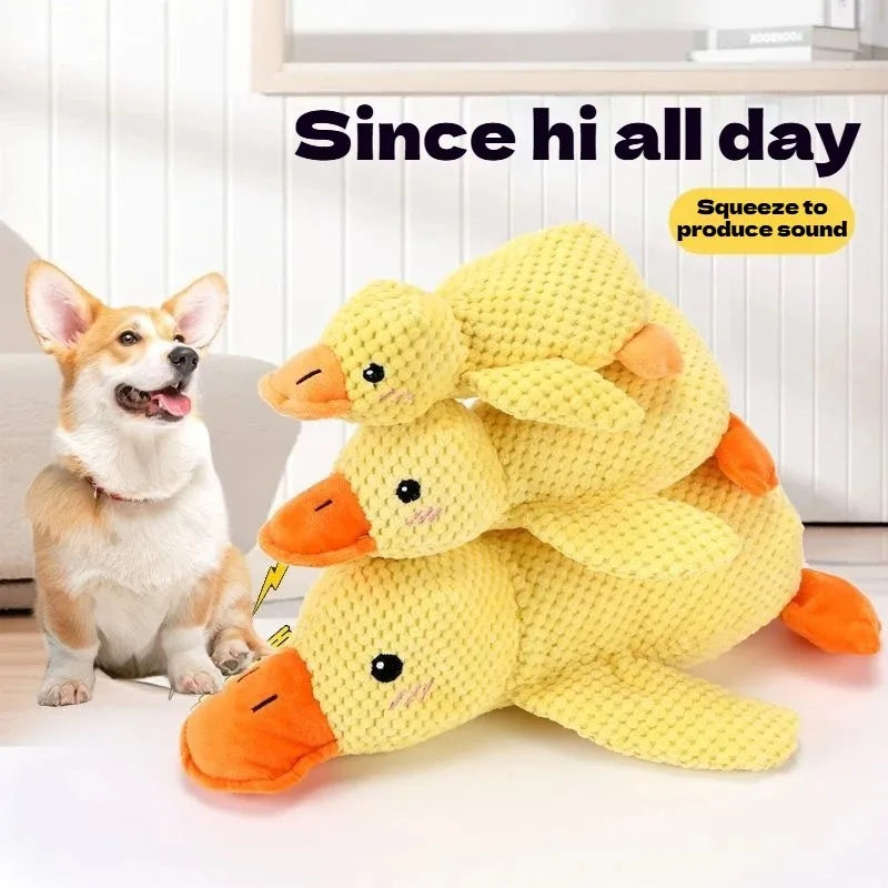 A yellow plush toy shaped like a duck is shown next to a small dog, designed to produce sound.