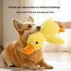 A dog is interacting with a yellow plush duck toy.