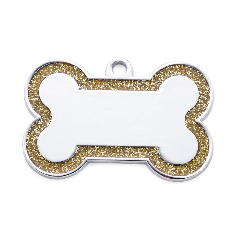 Silver pet ID tag with a bone shape, featuring gold glitter trim and a blank white center.
