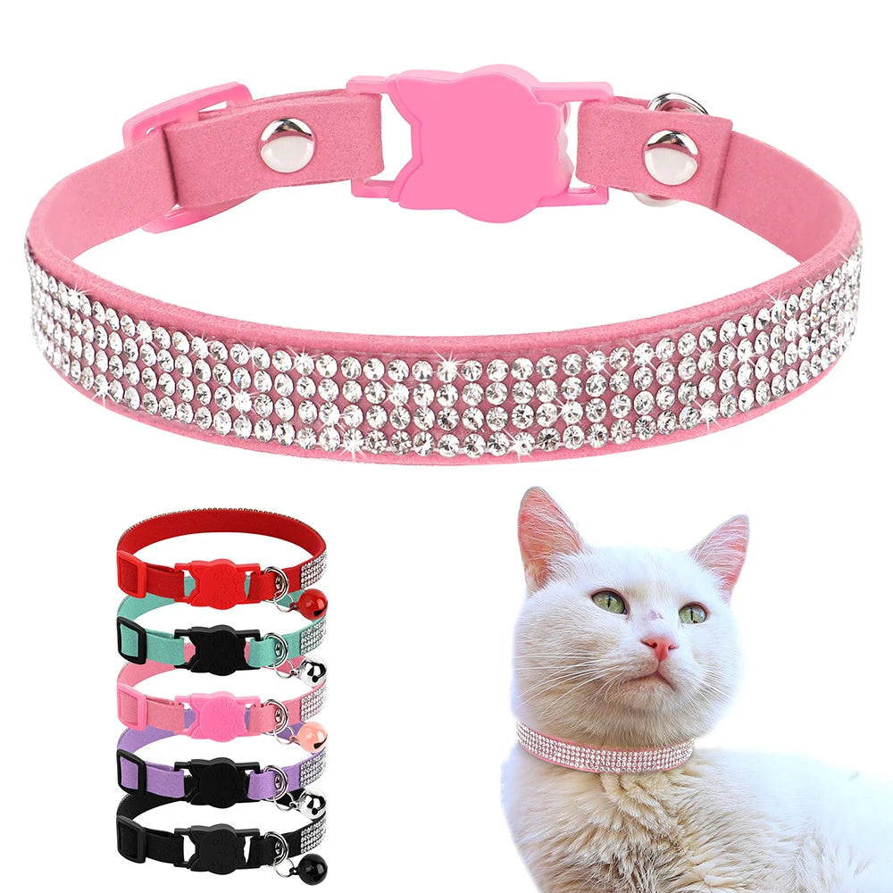 Pink suede rhinestone cat collar with a safety breakaway buckle shown next to a white cat.