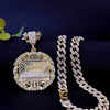 A gold plated last supper medallion pendant on a chain next to a Cuban link necklace.