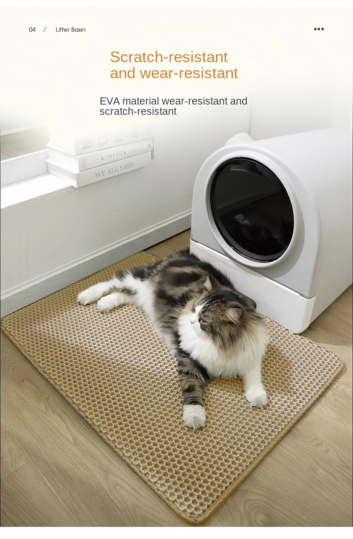 A gray and white cat is lying on a beige double-layer EVA cat litter mat next to a white litter box.