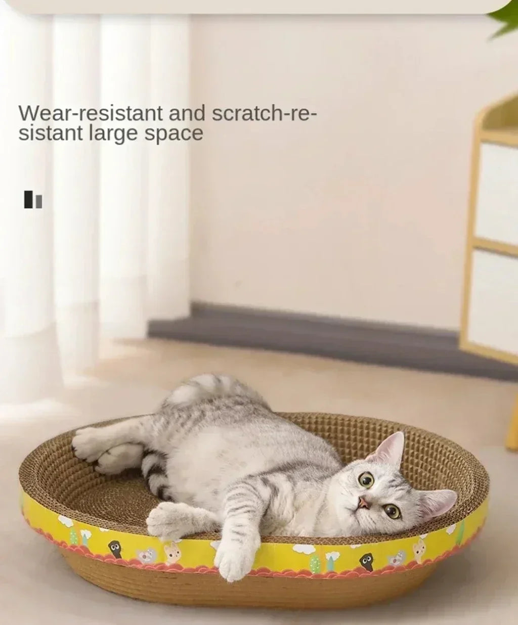A gray cat is relaxing in a round, woven scratching post designed for furniture protection.