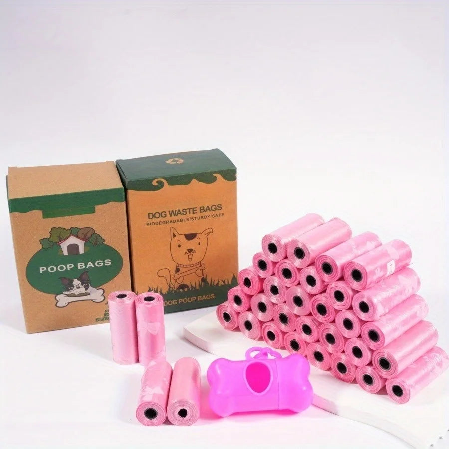 A pile of pink puppy crown patterned dog waste bags with leak-proof design and a pink dispenser roll.