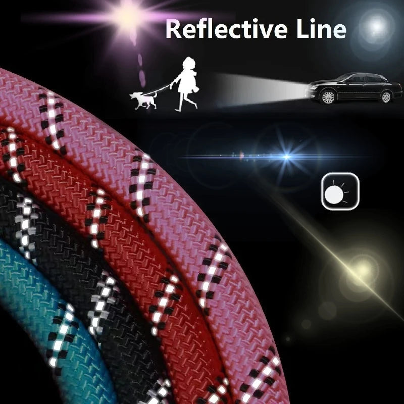 A close-up view of a red and black reflective line nylon dog leash with a soft padded handle against a dark background.