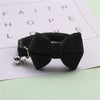 Black plush velvet pet collar featuring a bow and a silver bell
