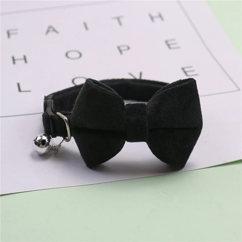 Black plush velvet pet collar featuring a bow and a silver bell