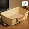 A large semi-enclosed cat litter box in beige plastic with a wooden scoop and litter, shown on a wooden floor.