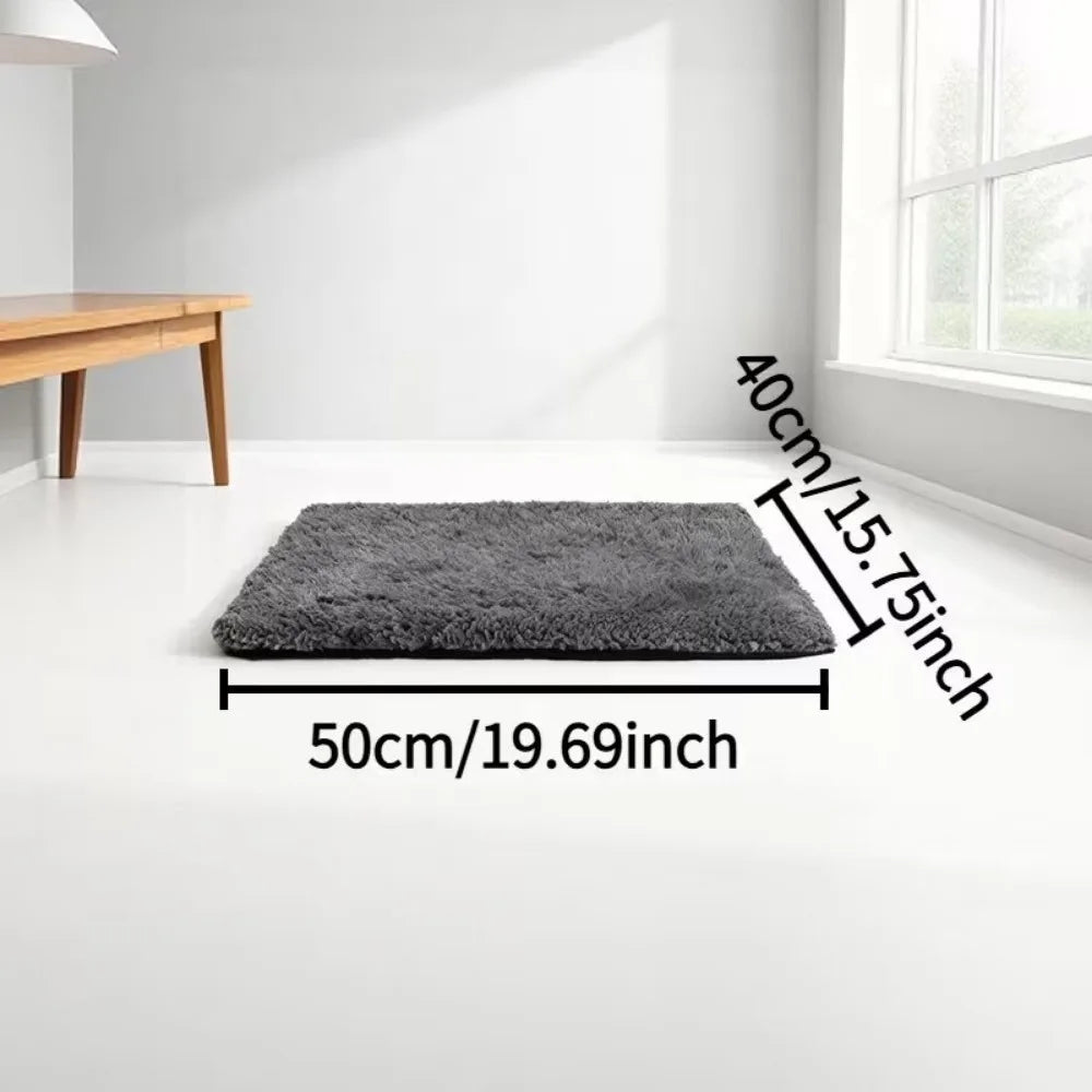 A rectangular gray self-warming cat mat with a non-slip base shown on a white floor.