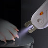 A white safety guard pet nail clipper is shown applying a focused beam of light to a cat's paw.