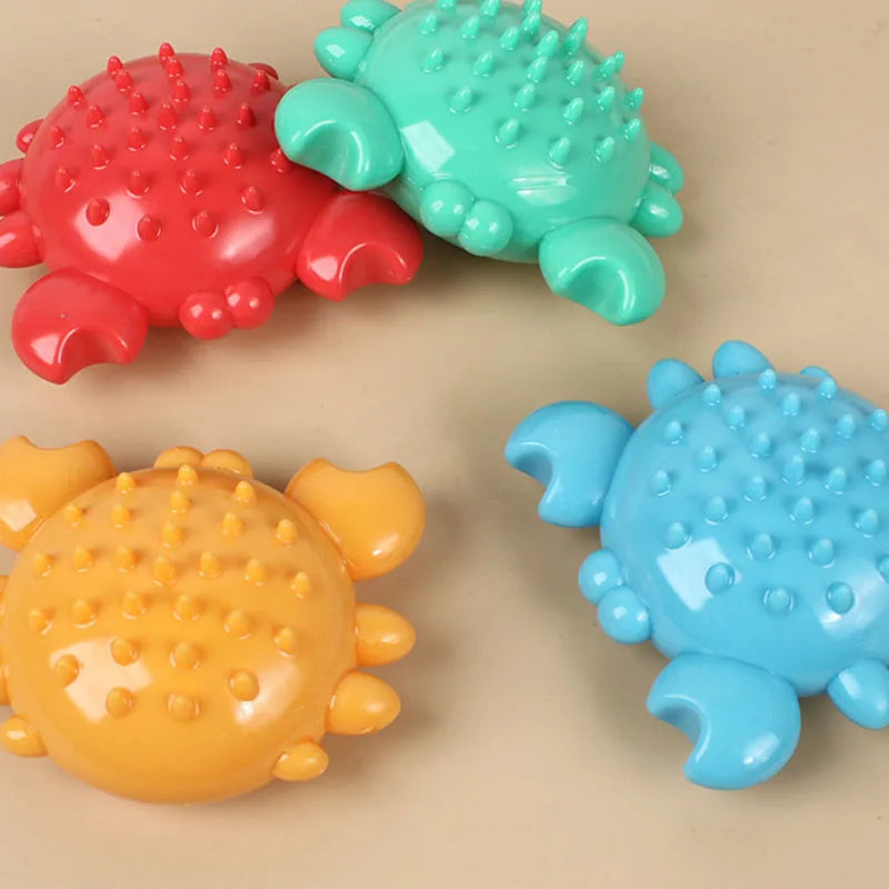 Three colorful squeaky chew toys for dogs shaped like turtles in red, green, and yellow.