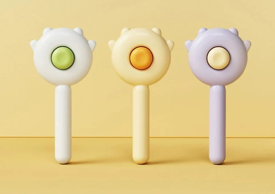 Three grooming tools featuring round heads in white, yellow, and purple tones.