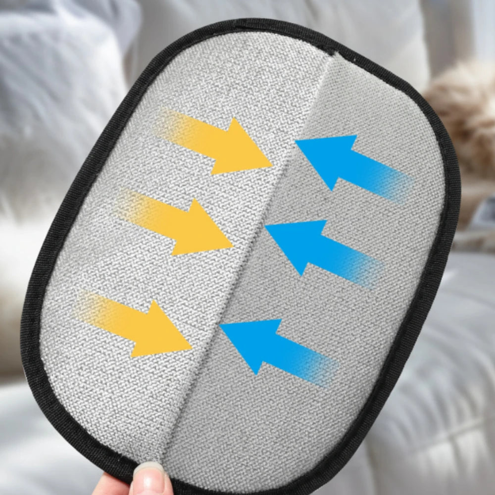 A hand holds a pet hair removal grooming glove with various colored arrows on a gray fabric background.