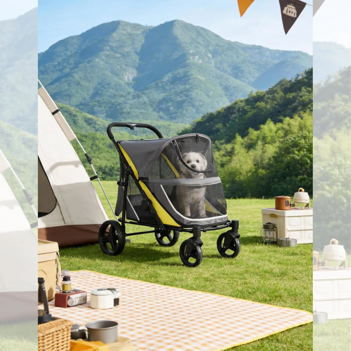 A gray all-terrain dog stroller is parked on a green lawn with mountains and trees in the background.