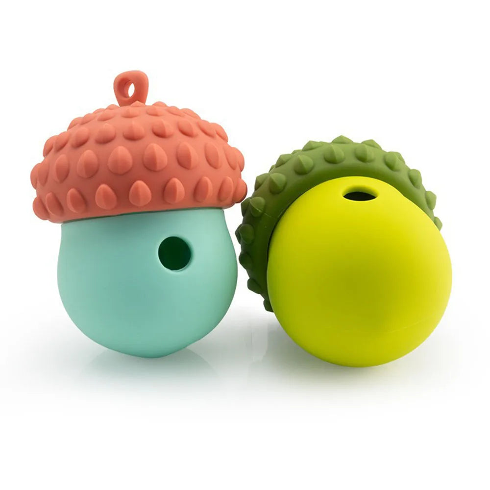 An orange textured puzzle feeder toy with a green ball component for dogs and cats.