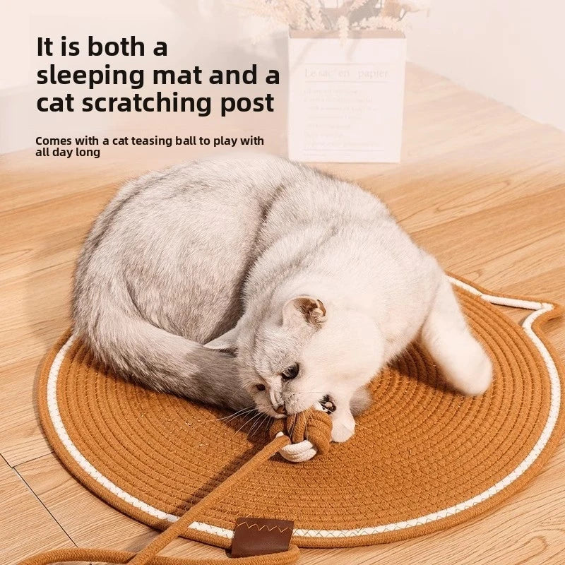 A gray cat is playing with a wooden ball on an orange scratching mat.