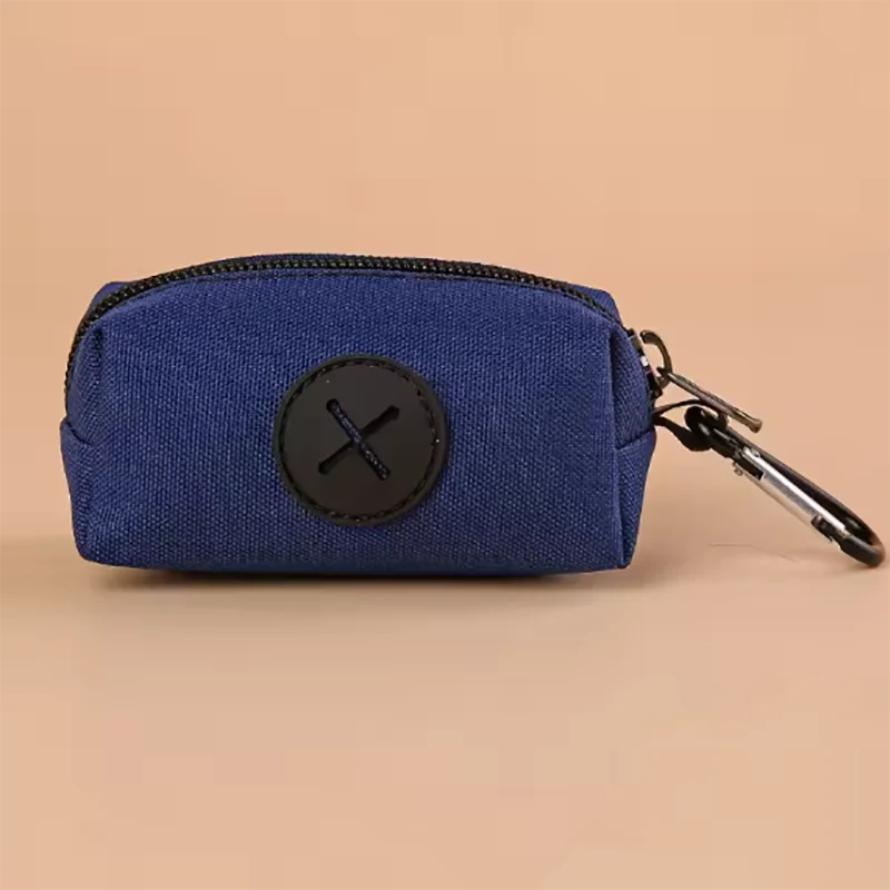 A dark blue fabric pouch with a black circular logo and attached to a metal carabiner clip.