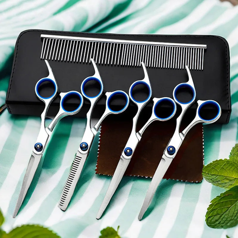 A set of professional stainless steel pet grooming scissors and a comb resting on a black case.