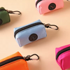A collection of small fabric pouches and bags in various pastel colors like pink, mint green, and blue, featuring metal clasp