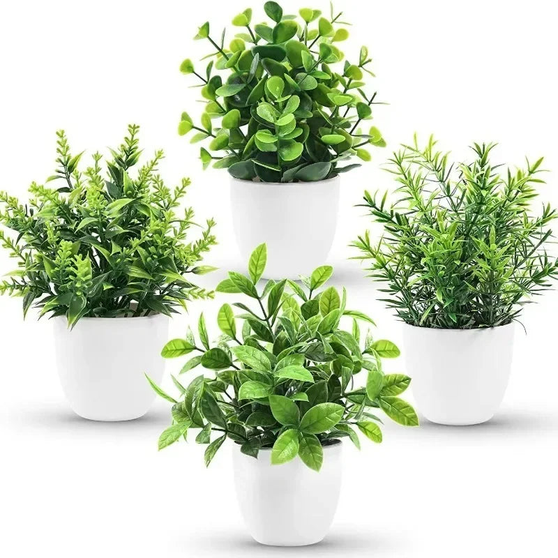 A collection of artificial bonsai potted plants in white ceramic pots.