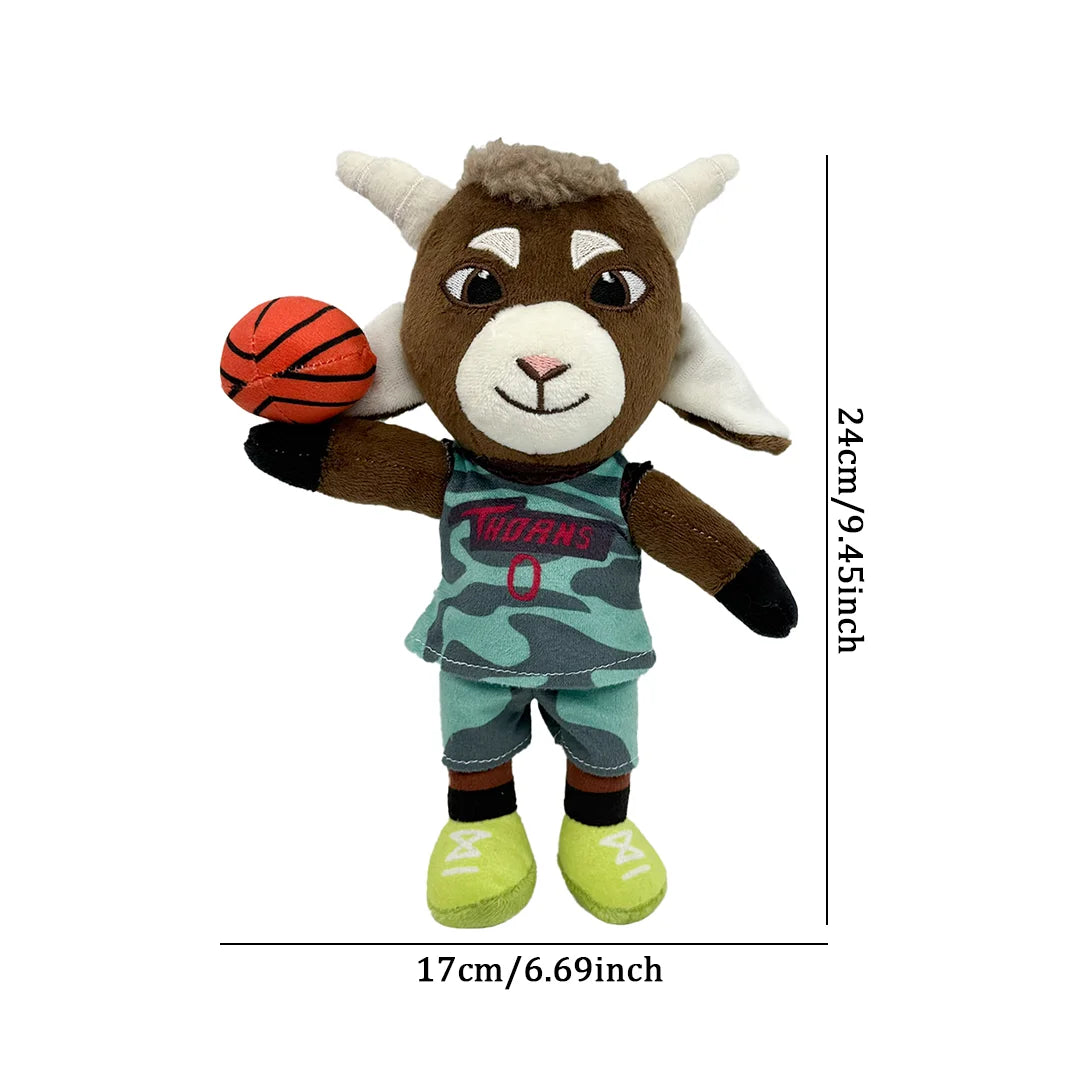 A brown goat plush toy dressed in a green and black soccer uniform holding a red and black ball.