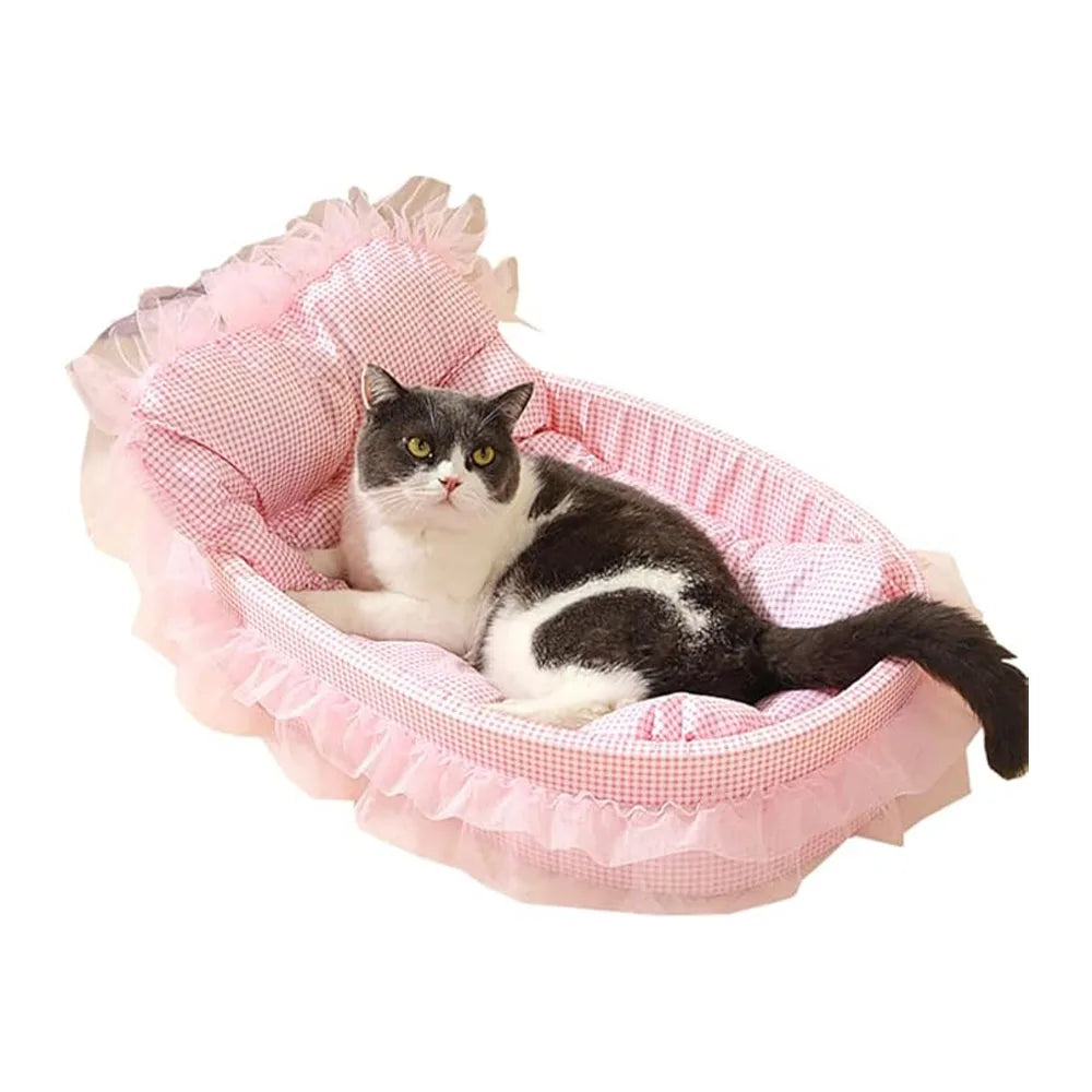 A black and white cat is relaxing in a pink lace-trimmed plush pet sofa bed.
