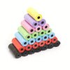 A pyramid stack of colorful biodegradable pet poop bags for dogs and cats in various shades of pink, green, yellow, and blue.