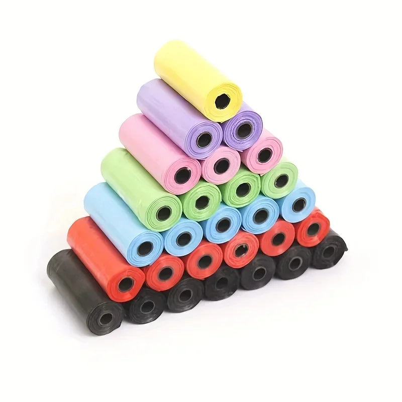 A pyramid stack of colorful biodegradable pet poop bags for dogs and cats in various shades of pink, green, yellow, and blue.