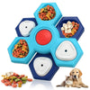 A blue and teal puzzle feeder bowl for dogs with various food items and a cat and a dog nearby.
