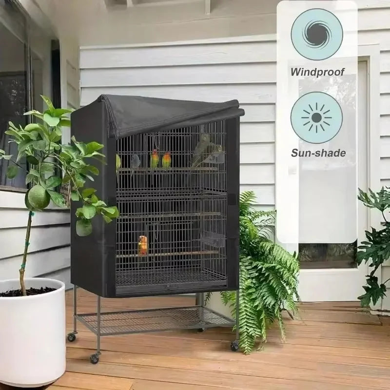 A black bird cage cover with a wire mesh design is placed on a wooden deck next to a window.